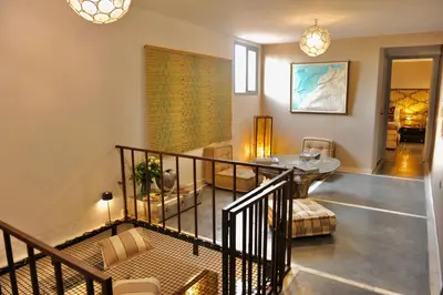 a room with a staircase with a table and chairs at Riad Home Zemrane in Marrakech