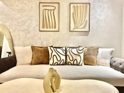 a living room with a couch with pillows at Magnifique appartement Résidence DOMAINE DE NORIA in Marrakech