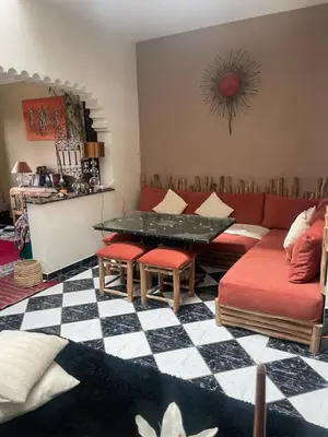 a living room with a couch and a table at Riad Palmier fleuri in Marrakech