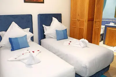 two beds with towels on them in a room at Riad ZANOUBA in Marrakech