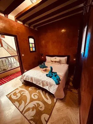 a bedroom with a bed with a stuffed animal on it at RIAD ZAKARYA in Marrakech