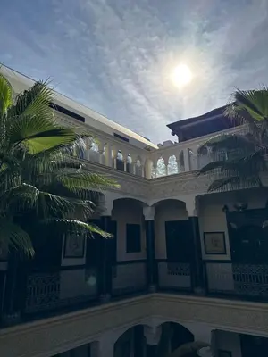 a house with the sun shining on the balcony at Riad Palais Didier Six in Marrakech
