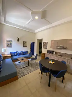 a living room with a couch and a table at Comfy Colonial Apartments in Marrakech