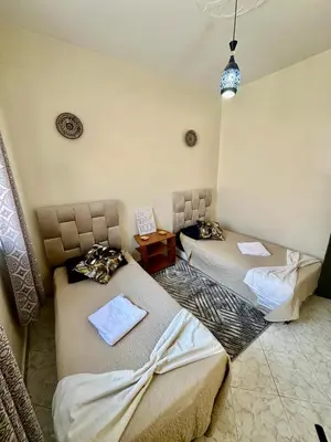 a room with two beds in a room at Lovely 2-bedroom appartement in Marrakech