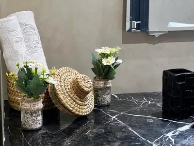 three vases with flowers in them on a table at Moderne, lumineux & spacieux avec balcon -Central -Wifi-Smart TV-Clim in Marrakech