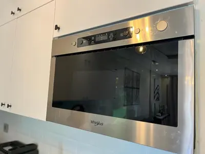 a stainless steel microwave oven in a kitchen at Appartement de Luxe -Prestigia Marrakech Golf City in Marrakech