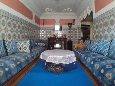 a living room with a couch and a table at House of Travelers in Marrakech in Marrakech