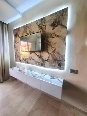 a bathroom with a stone wall with a mirror at Cozy Atlas Golf Studio Prestigia Marrakech in Marrakech