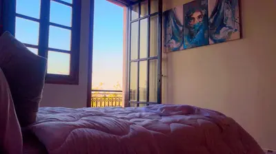 a bedroom with a bed and a large window at Villa Marrakech in Marrakech