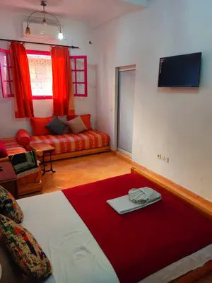 a living room with a bed and a couch at Dar Baddi in Marrakech