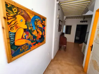 a painting hanging on a wall in a hallway at Dar Baddi in Marrakech