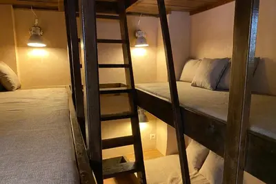 a room with two bunk beds and a ladder at Riad Of The Storks in Marrakech