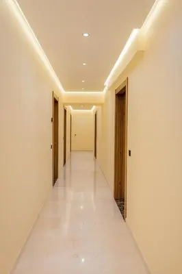 an empty corridor with white walls and a long hallway at Appartement Nour 5 Marrakech Centre Gueliz avec piscine in Marrakech
