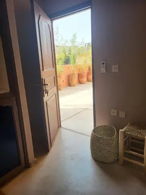 an open door leading to a patio with a view of a yard at Riad MsHolidays bassin privatisé Marrakech in Marrakech