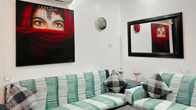 a living room with a couch and a painting on the wall at BAGATELLE STUDIO GUELIZ in Marrakech