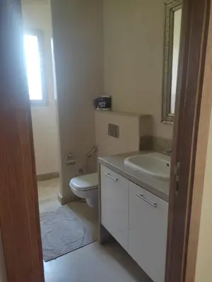 a bathroom with a toilet and a sink and a mirror at Villa isolée 4 façades avec piscine in Marrakech