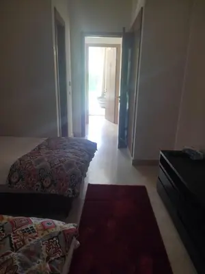 a room with two beds and a hallway with a door at Villa isolée 4 façades avec piscine in Marrakech