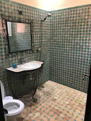 a bathroom with a sink and a mirror at Riad Syrine in Marrakech