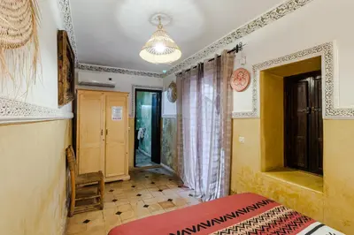 a bedroom with a bed in a room with a window at Riad Davina in Marrakech