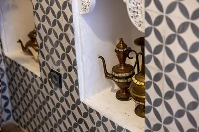 a tea kettle on a shelf in a bathroom at Riad Davina in Marrakech
