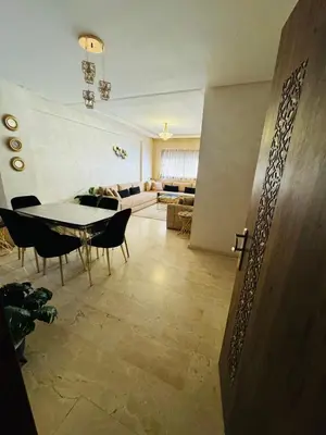 a living room with a table and chairs and a couch at Guéliz l’hivernage nour5 in Marrakech