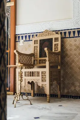 a chair in a room with a tiled wall at Riad Ksar Al Amal & Spa in Marrakech