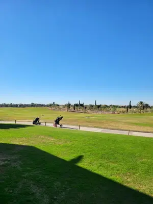 a shadow of a person riding a motorcycle on a road at Al Maaden Ryad 69 a Marrakesh in Marrakech