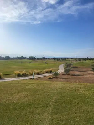 a walkway through a field with grass and trees at Al Maaden Ryad 69 a Marrakesh in Marrakech