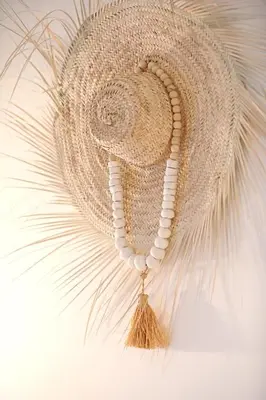 a straw hat with a tassel on a wall at Riad Amya & Spa in Marrakech