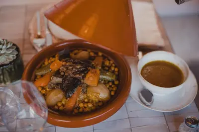 a bowl of food with beans and a cup of coffee at Riad Tizou in Marrakech