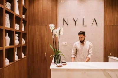 a man standing in front of a counter in a store at Riad Nyla Wellness and Spa in Marrakech