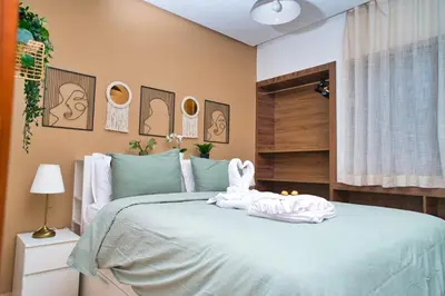 a bedroom with a bed with towels on it at Prestigia, superbe appartement, vue sur golf, piscine et Atlas in Marrakech