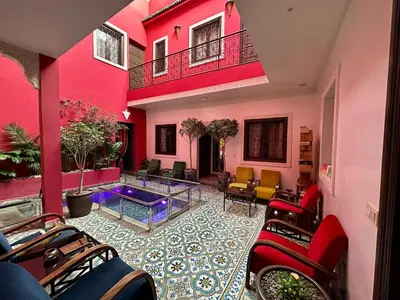a room with a pool in the middle of a building at Riad Hilmuna Hammam et Spa in Marrakech