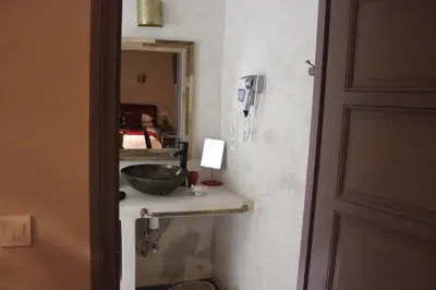 a bathroom with a bowl on a counter next to a door at Riad Hilmuna Hammam et Spa in Marrakech