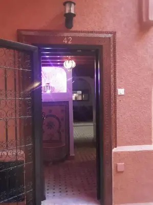 a hallway with a mirror in a room at Un Riad pour se divertir en famille & se détendre in Marrakech