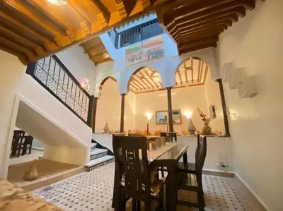 a dining room with a table and chairs at Un Riad pour se divertir en famille & se détendre in Marrakech