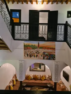a room with stairs and a painting on the wall at Un Riad pour se divertir en famille & se détendre in Marrakech