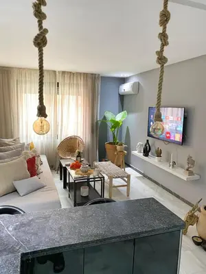 a living room with a couch and a table at Vitality Home in Marrakech