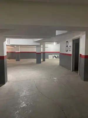 an empty parking garage with a large room with a door at Vitality Home in Marrakech