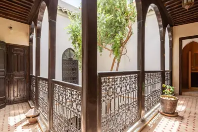 an entrance to a house with an iron fence at Riad les épices in Marrakech