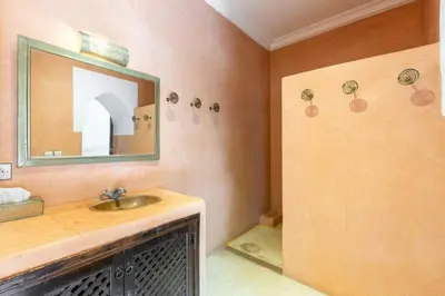a bathroom with a sink and a mirror at Riad les épices in Marrakech