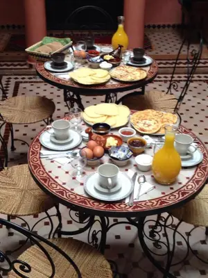 a table with plates of food on top at Riad Mounlight in Marrakech