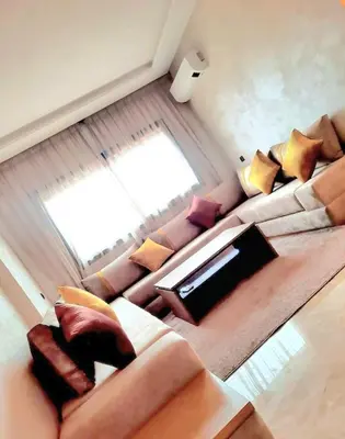 a living room with a couch and a window at appart Marrakech in Marrakech