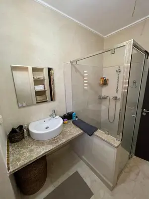 a bathroom with a sink and a shower at villa jardin de l'Atlas in Marrakech