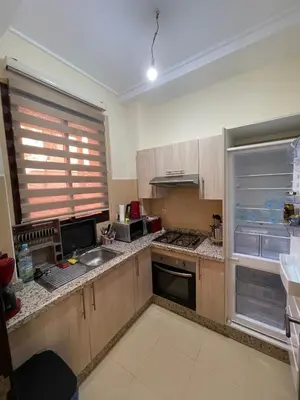 a kitchen with an open refrigerator and a sink at villa jardin de l'Atlas in Marrakech
