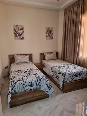 a bedroom with two beds and a window at Marrakech medina inn in Marrakech