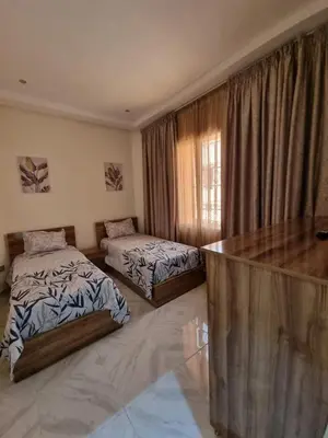 a bedroom with two beds and a wooden counter at Marrakech medina inn in Marrakech
