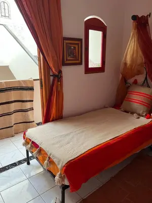 a bedroom with a bed with a mirror and a window at Riad Sofia signature in Marrakech