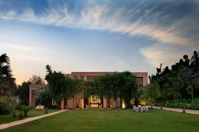 a building with a lawn in front of it at Pavillon Terra Ababila en Exclusivité in Marrakech