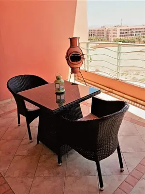 a table and chairs in a room with a window at HERMINIE ATLAS in Marrakech